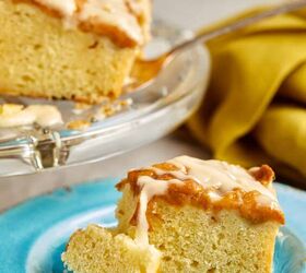 easy peach cobbler pound cake with brown butter glaze, close up shot of a piece of cake on a blue plate with a piece of cake on a fork