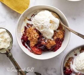 easy peach cobbler pound cake with brown butter glaze, A bowl of berry crumble topped with a scoop of vanilla ice cream accompanied by a spoon on a marbled surface with another similar dish nearby