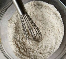 easy peach cobbler pound cake with brown butter glaze, looking down at clear bowl with dry ingredients mixed with a whisk