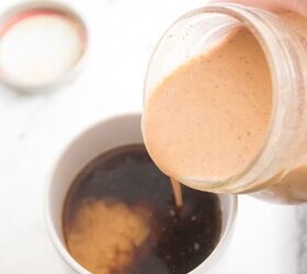 homemade pumpkin spice coffee creamer recipe, Pouring homemade pumpkin flavored creamer into a black coffee