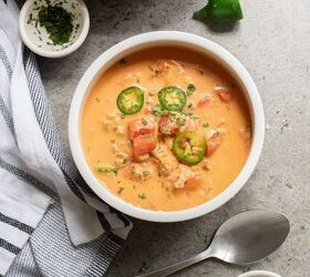 keto taco soup a flavorful and easy low carb meal, A bowl of soup garnished with sliced jalape os and herbs beside a spoon and striped napkin on a gray surface