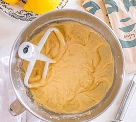 starbucks copycat lemon loaf, A mixing bowl with lemon cake batter surrounded by lemons a grater and paper bags on a countertop