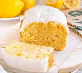 starbucks copycat lemon loaf, Lemon loaf cake with white icing sliced on a cutting board fresh lemons in the background