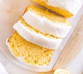 starbucks copycat lemon loaf, Sliced lemon loaf with white icing next to a zested lemon and a grater on a marble surface