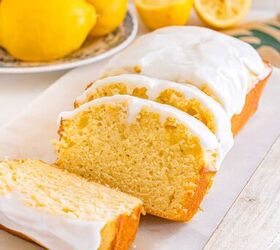 starbucks copycat lemon loaf, A loaf of lemon bread with white icing partially sliced sits on a marble board next to fresh lemons