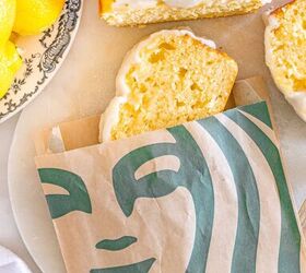 starbucks copycat lemon loaf, A slice of iced lemon loaf in a Starbucks bag beside the rest of the loaf and fresh lemons on a plate