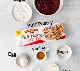 cherry turnovers, Top down view of ingredients for making cherry turnovers displayed on a gray surface Includes cherry pie filling powdered sugar puff pastry sheets an egg vanilla sugar water and milk with labels identifying each item