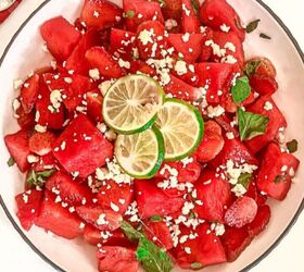 refreshing watermelon strawberry salad recipe, Top down view of watermelon strawberry salad with feta cheese mint and lime in a white bowl beside lime slices