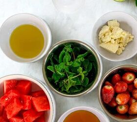refreshing watermelon strawberry salad recipe, Flat lay of ingredients for watermelon strawberry salad including watermelon cubes strawberries mint honey olive oil feta cheese lime and salt