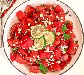 refreshing watermelon strawberry salad recipe, Top down view of watermelon strawberry salad with feta mint and lime in a white bowl beside lime slices