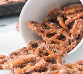 refreshing watermelon strawberry salad recipe, A white cup filled with oven baked cinnamon pretzels in front of a batch cooling on a tray