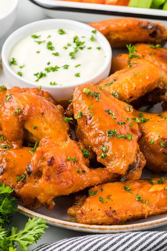 buffalo honey wings, These flavorful Buffalo Honey Wings are baked and then glazed with a honey buffalo sauce that takes these wings over the top The honey slightly mellows the hot sauce and adds amazing flavor you really can t eat just one These are delicious with your favorite blue cheese or ranch dip and are the perfect addicting appetizer for Game Day or your next gathering Here are the wings are on a serving plate with blue cheese dressing on the side