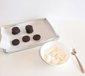 halloween jack skellington cookies with oreos, Oreo cookies arranged on a parchment lined baking sheet next to a bowl filled with white candy melts