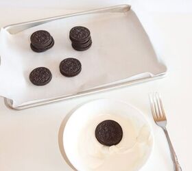 halloween jack skellington cookies with oreos, An Oreo cookie dipped in melted white chocolate with more Oreos on a baking sheet lined with parchment paper