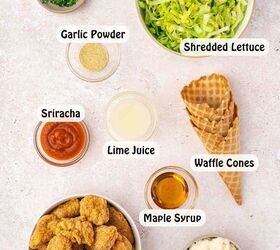 spicy chicken waffle cones with creamy sriracha sauce, Flatlay of ingredients including waffle cones chicken nuggets shredded lettuce sriracha mayo and seasonings arranged on a kitchen surface