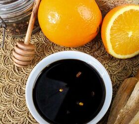 quick and easy teriyaki orange sauce recipe, Overhead view of teriyaki orange sauce in a white bowl with red pepper flakes styled with oranges honey dipper and jars of spices and grains
