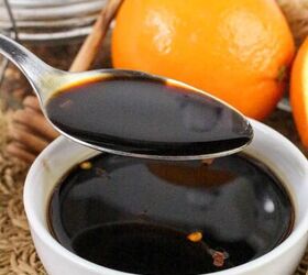quick and easy teriyaki orange sauce recipe, Spoon scooping thick homemade teriyaki orange sauce from a white bowl with fresh oranges and honey dipper in the background