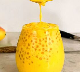quick and easy teriyaki orange sauce recipe, A spoon dripping creamy mango sago pudding into a glass filled with tapioca pearls and rich mango coconut mixture