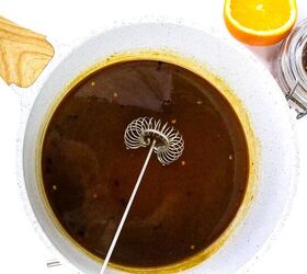 quick and easy teriyaki orange sauce recipe, Whisk stirring dark brown teriyaki orange sauce in a white saucepan