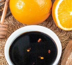 quick and easy teriyaki orange sauce recipe, Close up bowl of homemade teriyaki orange sauce with red pepper flakes surrounded by fresh oranges honey dipper and grains