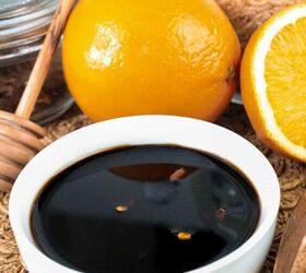 quick and easy teriyaki orange sauce recipe, White bowl filled with glossy teriyaki orange sauce placed near whole and halved oranges honey dipper and glass jars