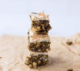 cinnamon rice cake protein bars with dates maple cream cheese frost, Cinnamon Rice Cake Protein Bars with Dates Cream Cheese Frosting 3 stacked on top of each other on top of a piece of parchment paper