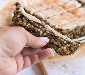 cinnamon rice cake protein bars with dates maple cream cheese frost, hand holding up a single cinnamon rice cake protein bar with the other bars in the background