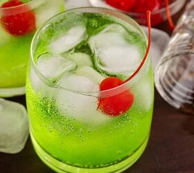 grinch cocktail, Green Grinch Cocktail Over Ice with Maraschino Cherry