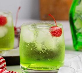 grinch cocktail, Green Grinch Cocktail Over Ice with Maraschino Cherry