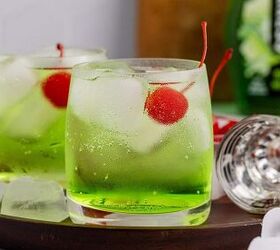 grinch cocktail, Green Grinch Cocktail Over Ice with Maraschino Cherry