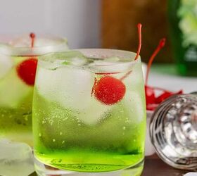 grinch cocktail, Green Grinch Cocktail Over Ice with Maraschino Cherry