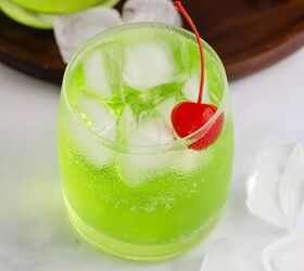 grinch cocktail, Green Grinch Cocktail Over Ice with Maraschino Cherry