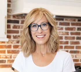 lemon brownies recipe, Person with shoulder length blond hair and blue glasses smiling indoors in front of a red brick wall