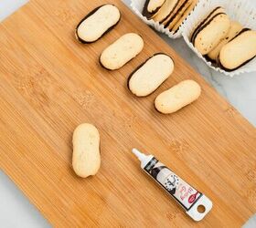 graveyard dirt cake cups easy no bake halloween, Plain Milano cookies on a cutting board with black decorating gel ready to write RIP for Halloween dirt pudding cups