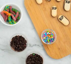 graveyard dirt cake cups easy no bake halloween, Halloween dirt cake cup toppings including RIP Milano cookie gravestones gummy worms and colorful sprinkles for decorating