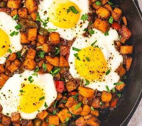 skillet sweet potato breakfast hash easy one pan recipe, Close up of crispy golden sweet potato cubes and perfectly cooked eggs in a cast iron skillet garnished with fresh parsley