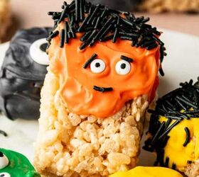 Close up of Halloween Rice Krispie Treats decorated with candy eyes and drizzled with orange and black chocolate