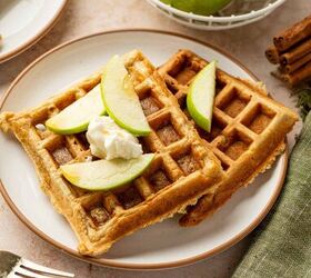 apple cinnamon waffles easy homemade waffle recipe, Golden brown cinnamon apple waffles on a white plate with fresh apple slices whipped cream and maple syrup