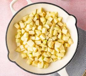 Fresh chopped apples being added to the skillet