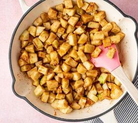 Spatula stirring glossy apple pie filling with tender apple slices
