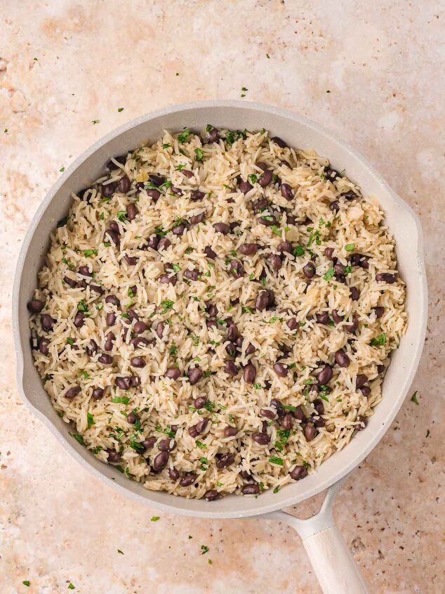 black beans and rice, Fully cooked black beans and rice in the skillet fluffed and garnished with chopped fresh cilantro