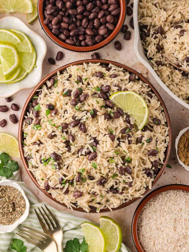 black beans and rice, Overhead shot of a serving bowl of black beans and rice with lime slices surrounded by small bowls of ingredients