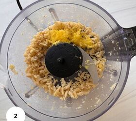 fresh mint pesto vegan gluten free, A food processor bowl containing blended cashews and a pile of grated lemon zest ideal for making mint pesto viewed from above The blade is visible and a white circle with the number 2 is in the bottom left corner