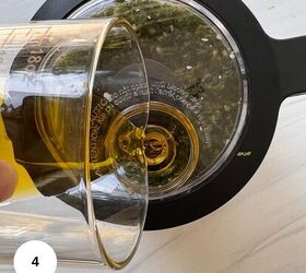 fresh mint pesto vegan gluten free, A glass measuring cup pours oil into a food processor filled with chopped green herbs for mint pesto viewed from above on a light countertop A white circle with the number 4 appears in the lower left corner