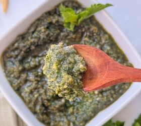 fresh mint pesto vegan gluten free, A close up of a wooden spoon holding a scoop of green mint pesto sauce above a white bowl filled with more pesto garnished with a mint leaf