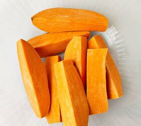 air fryer sweet potato wedges, Peeled and sliced sweet potatoes arranged in a clear glass bowl seen from above