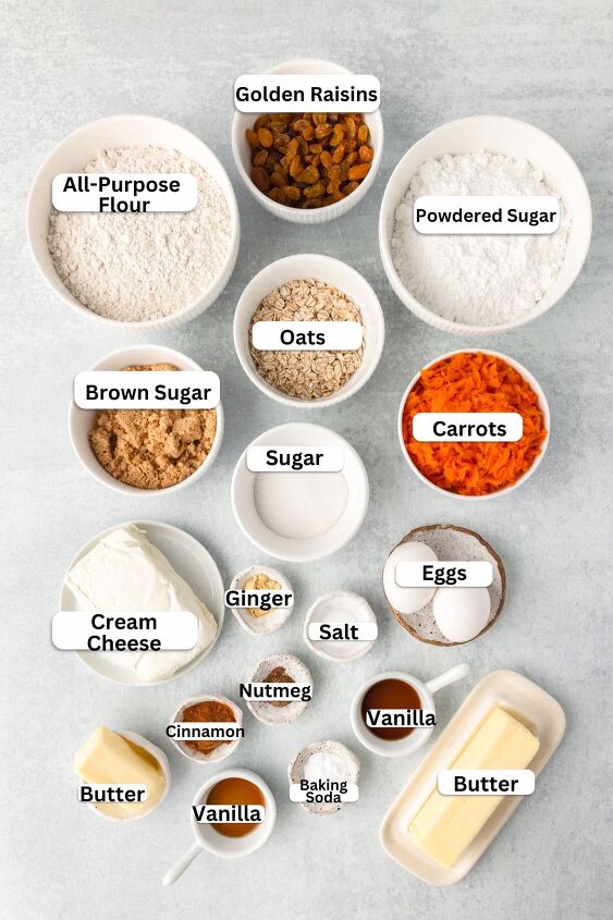 carrot cake cookies, Top down view of various baking ingredients in separate bowls golden raisins powdered sugar all purpose flour oats brown sugar granulated sugar shredded carrots cream cheese ginger nutmeg salt vanilla eggs baking soda and butter
