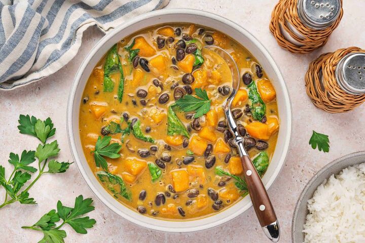 sweet potato black bean coconut curry easy one pot recipe, Hearty vegan coconut curry with sweet potatoes and spinach in a rustic bowl
