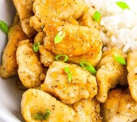 the best fireball apple cider drink for the fall season, Close up view of golden honey butter chicken with rice and chopped green onions