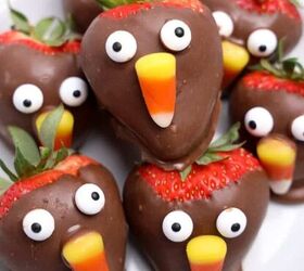 the best fireball apple cider drink for the fall season, Chocolate covered strawberries decorated with candy eyes and candy corn to look like cute Thanksgiving turkeys arranged on a white plate